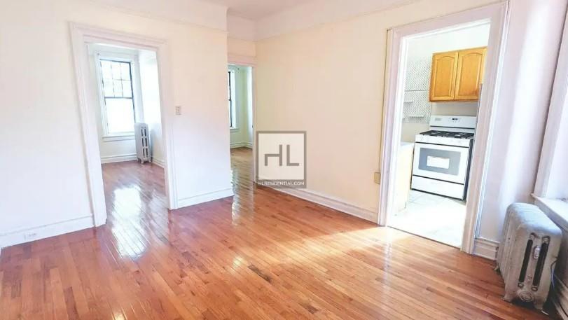 354 Rutland Road Brooklyn, NY 11225 - Photo 11 of 50 wooden floor in an empty room with a window