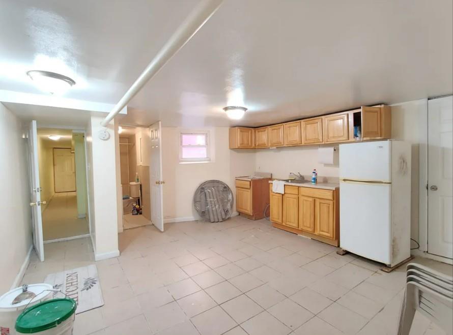 354 Rutland Road Brooklyn, NY 11225 - Photo 17 of 50 a view of a kitchen with refrigerator and white cabinets