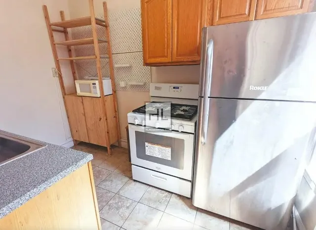 a kitchen with a stove top oven and cabinets