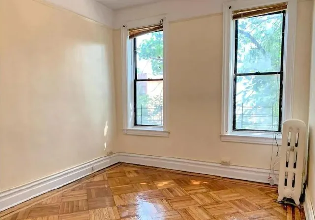 a front view of a house with plants