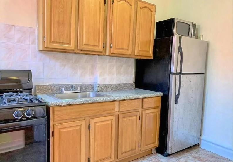354 Rutland Road Brooklyn, NY 11225 - Photo 25 of 50 a kitchen with stainless steel appliances granite countertop a refrigerator a stove a sink and dishwasher