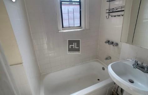 354 Rutland Road Brooklyn, NY 11225 - Photo 47 of 50 a bathroom with a bathtub