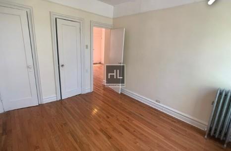 354 Rutland Road Brooklyn, NY 11225 - Photo 49 of 50 a view of an empty room with wooden floor and a window