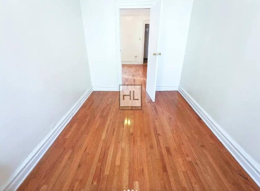 354 Rutland Road Brooklyn, NY 11225 - Photo 5 of 50 a view of a room with wooden floor and bench