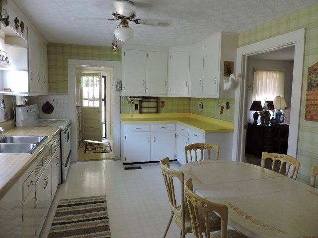 559 Lofton Road Raphine, VA 24472 - Photo 8 of 17 a kitchen with a table chairs refrigerator and cabinets