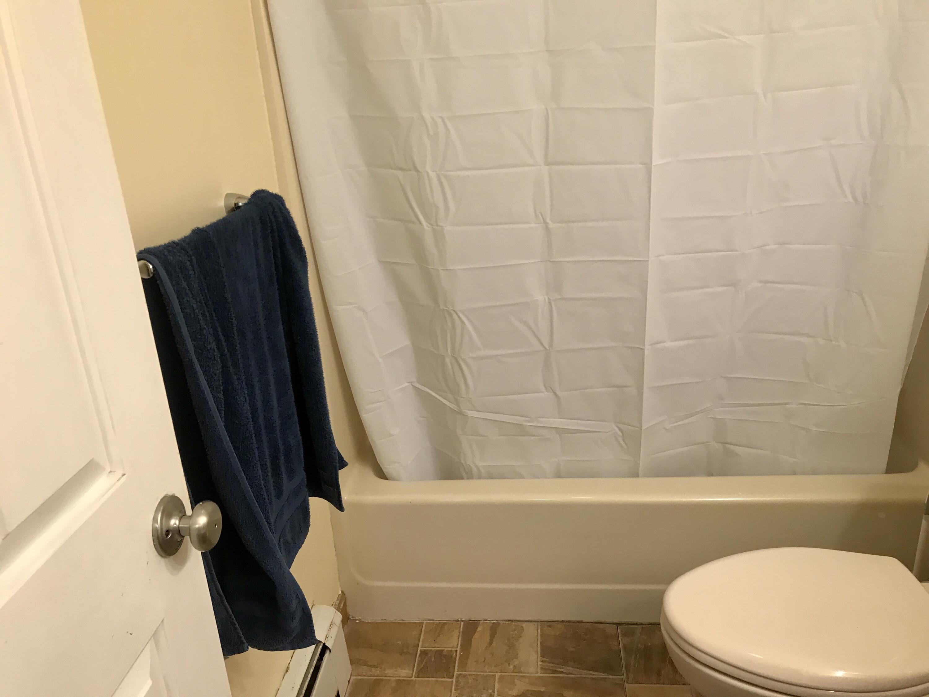 24 Papnomett Road Mashpee, MA 02649 - Photo 11 of 28 a bathroom with a toilet and a tub