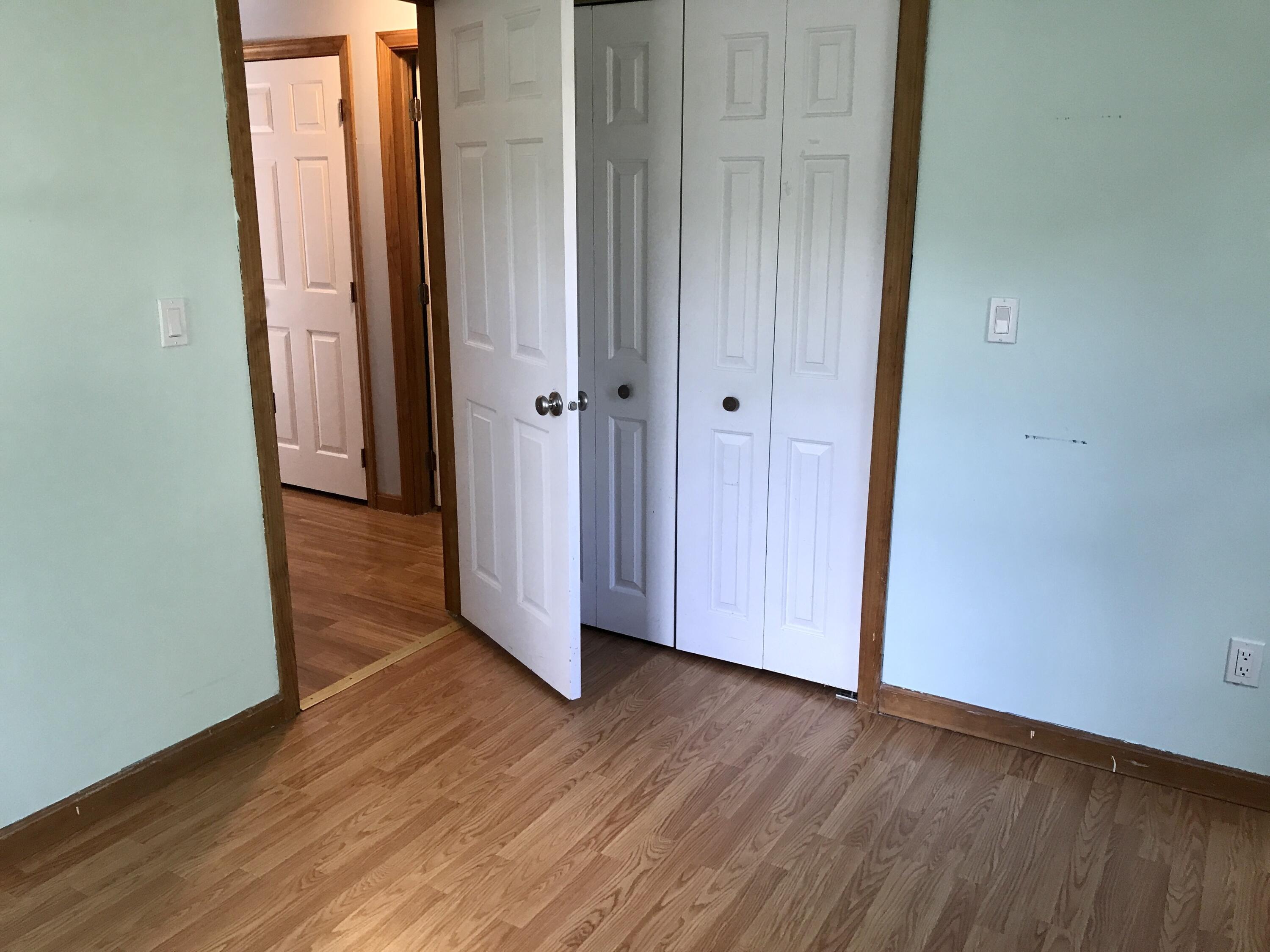 24 Papnomett Road Mashpee, MA 02649 - Photo 14 of 28 an empty room with wooden floor and entrance