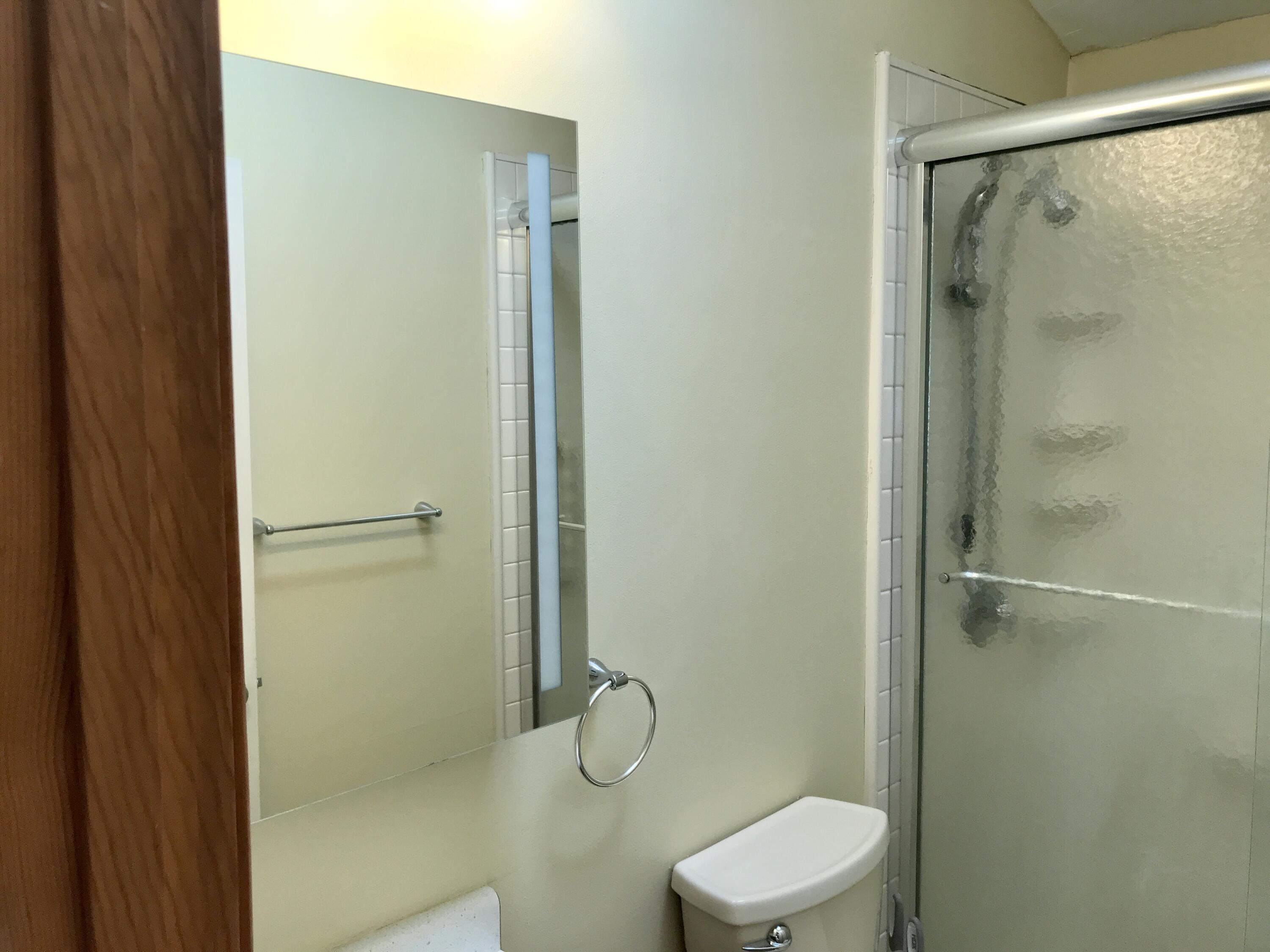 24 Papnomett Road Mashpee, MA 02649 - Photo 19 of 28 a bathroom with a granite countertop toilet and a shower