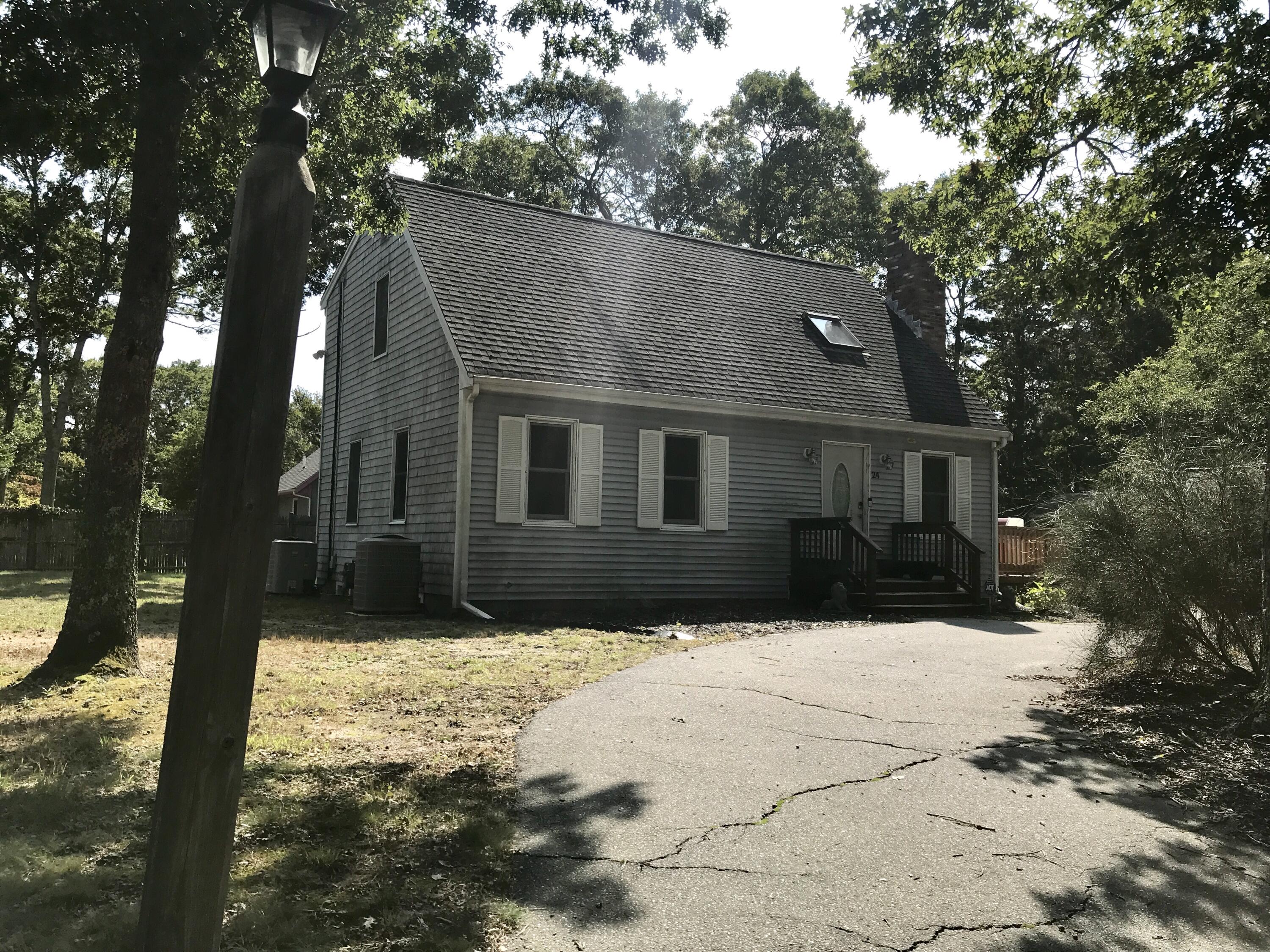 24 Papnomett Road Mashpee, MA 02649 - Photo 2 of 28 a front view of house with yard covered in snow