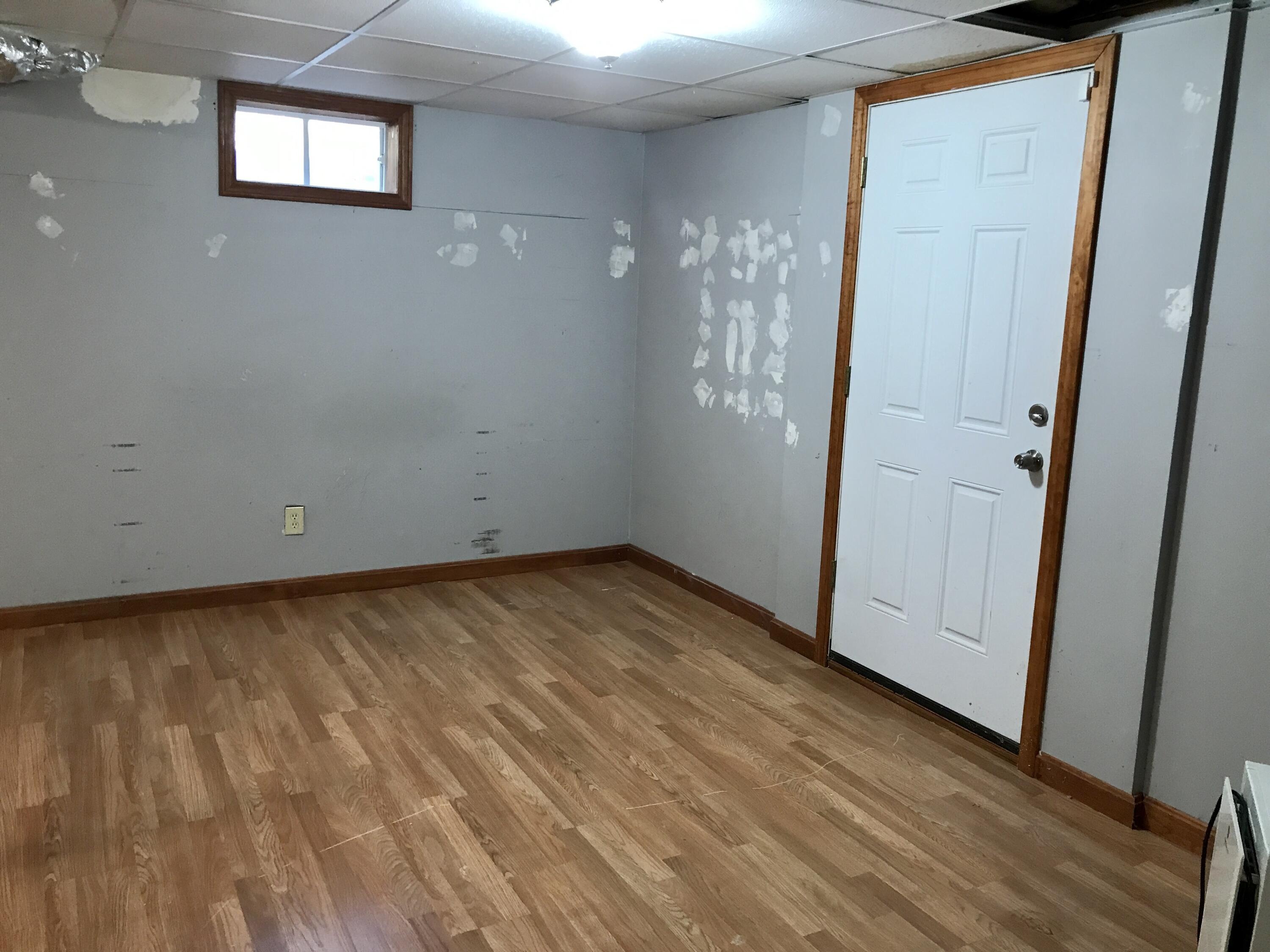 24 Papnomett Road Mashpee, MA 02649 - Photo 25 of 28 an empty room with wooden floor and windows