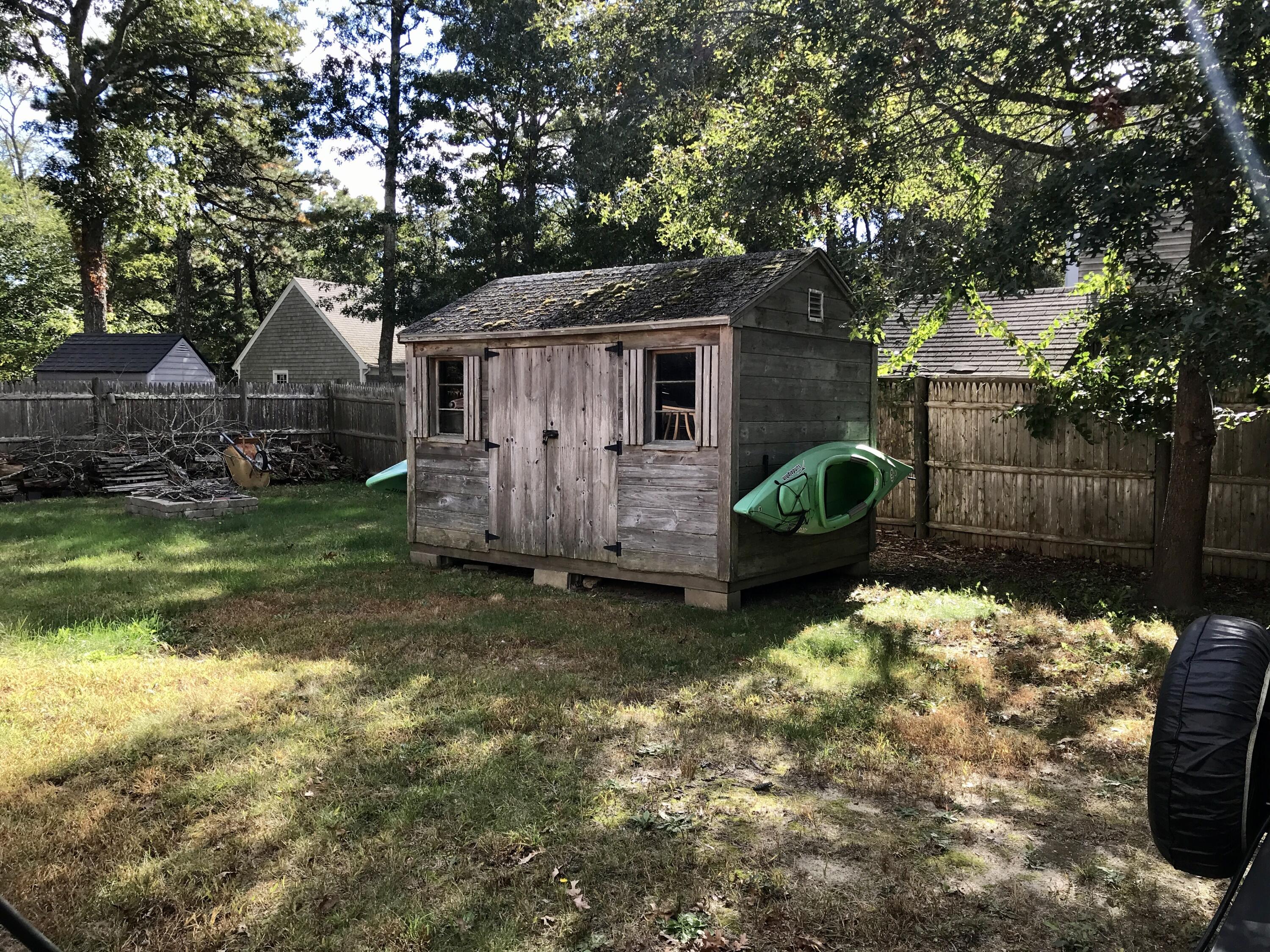 24 Papnomett Road Mashpee, MA 02649 - Photo 26 of 28 a backyard of a house with yard and outdoor seating