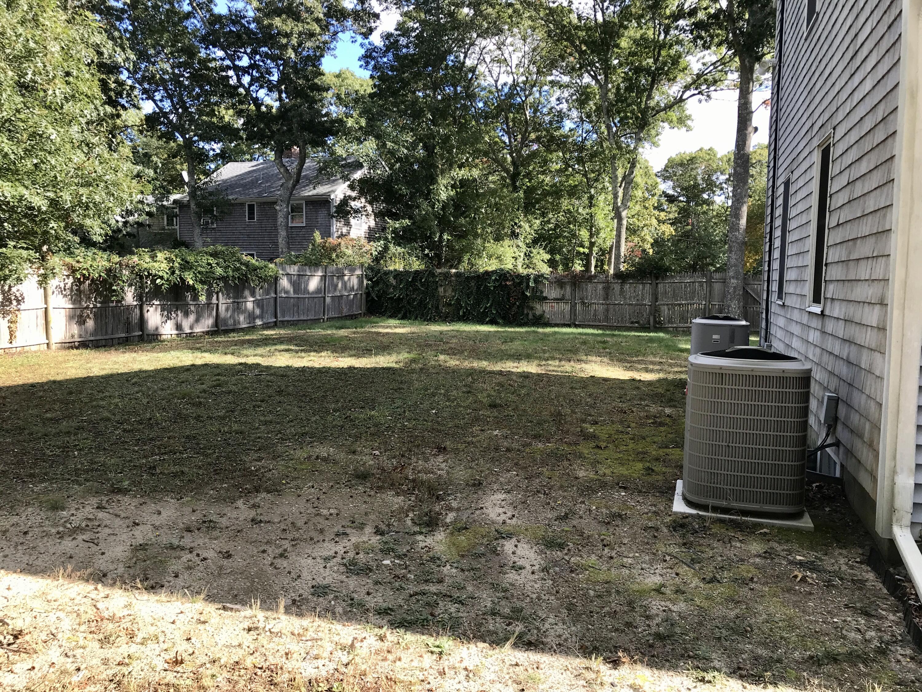24 Papnomett Road Mashpee, MA 02649 - Photo 27 of 28 a backyard of a house with lots of green space