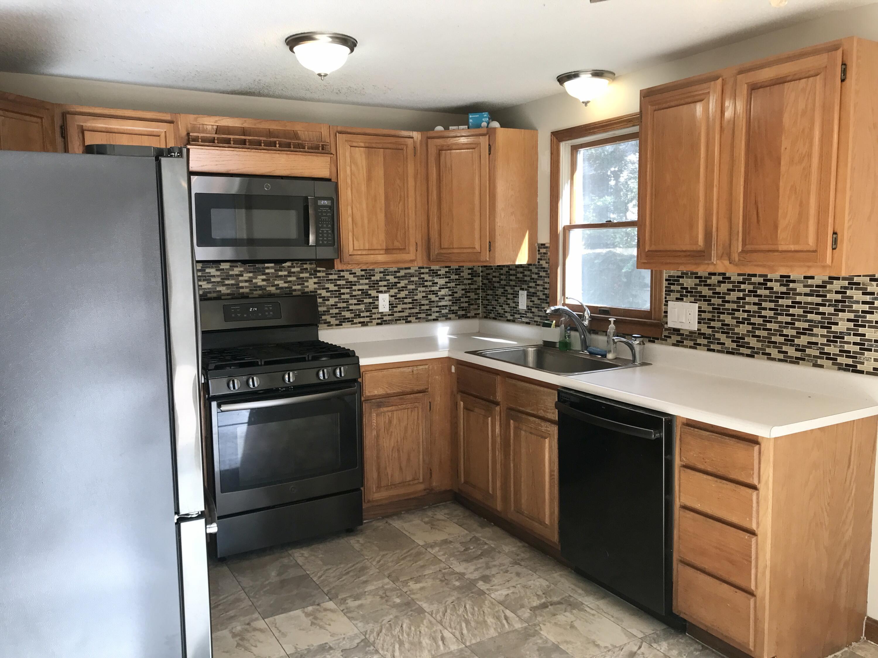 24 Papnomett Road Mashpee, MA 02649 - Photo 4 of 28 a kitchen with stainless steel appliances granite countertop a sink stove and refrigerator