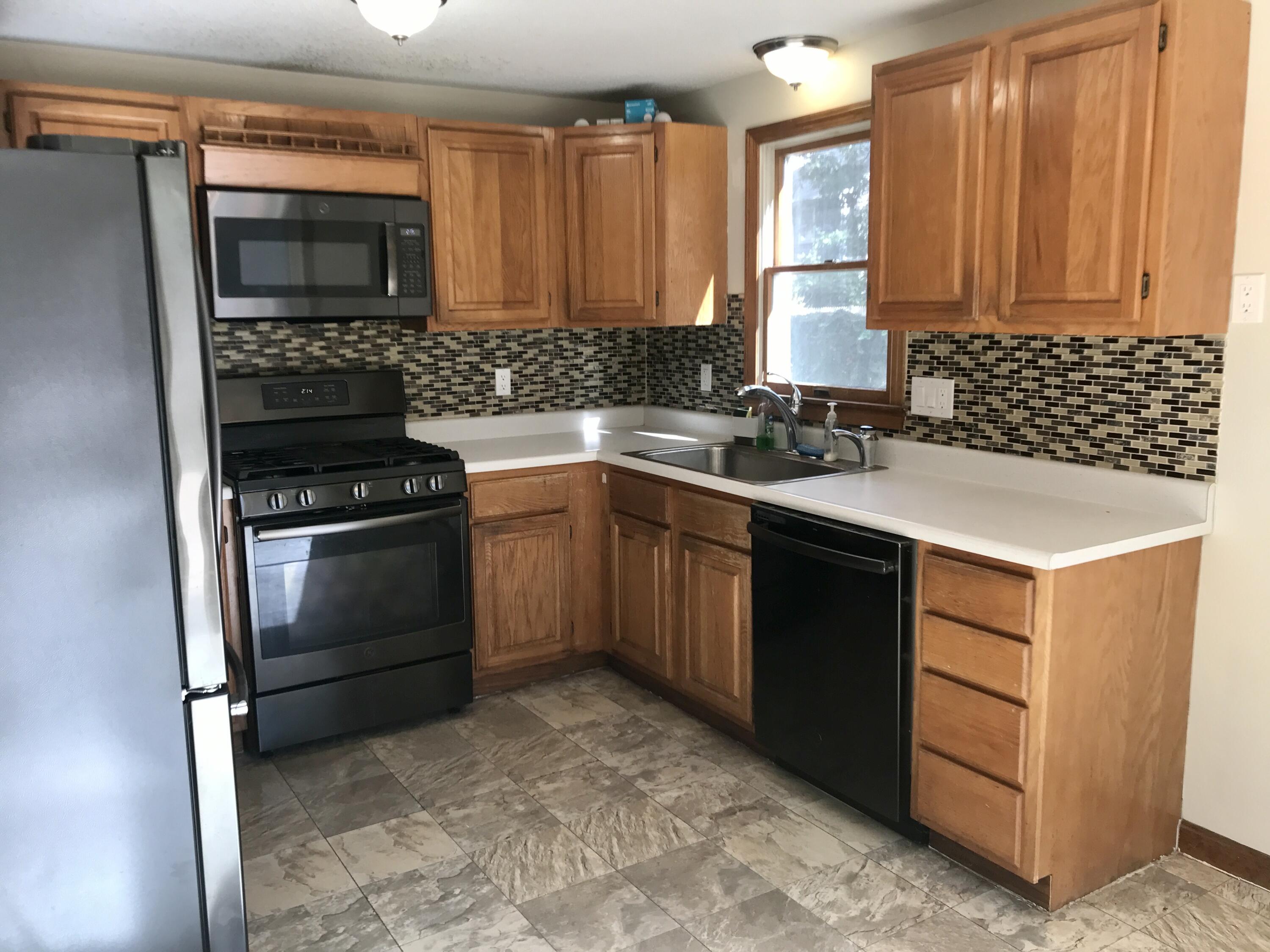 24 Papnomett Road Mashpee, MA 02649 - Photo 6 of 28 a kitchen with a sink stove and microwave