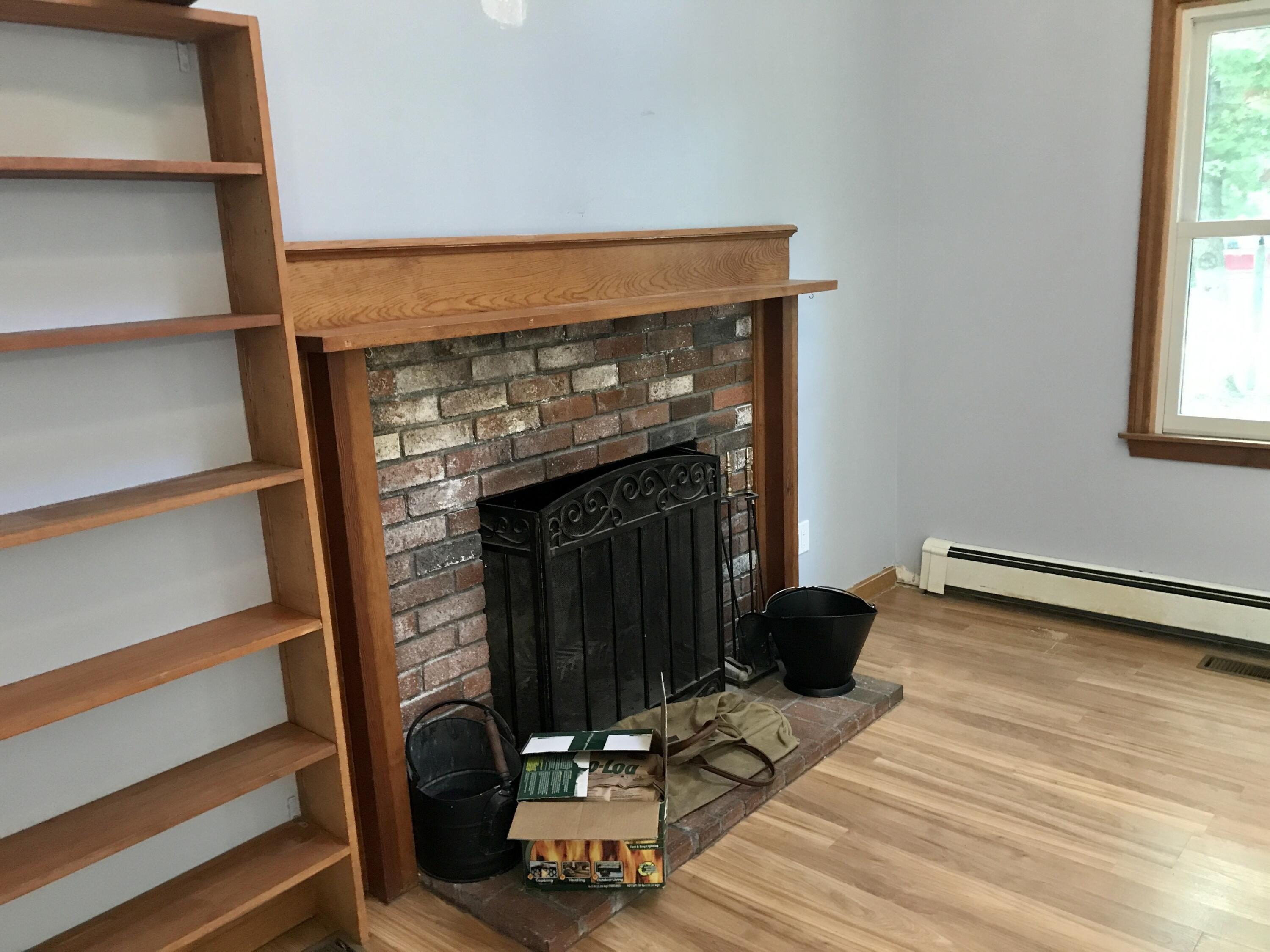 24 Papnomett Road Mashpee, MA 02649 - Photo 8 of 28 a living room with a fireplace and windows