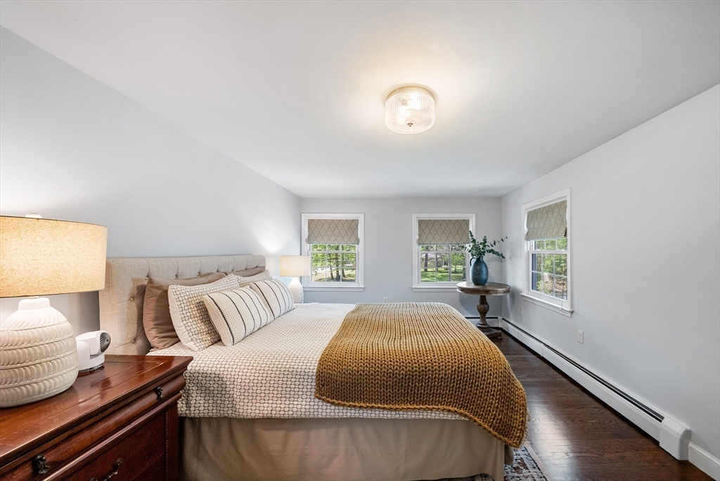 60 Perry Drive Westwood, MA 02090 - Photo 27 of 42 a spacious bedroom with a bed and wooden floor