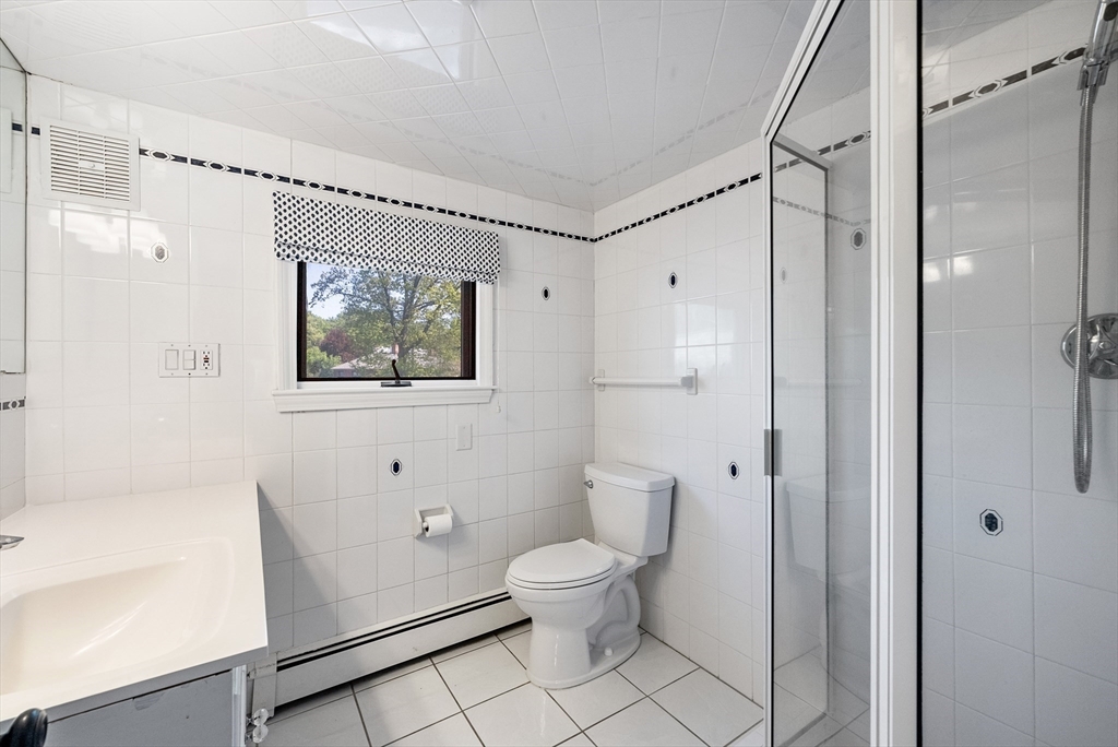 60 Perry Drive Westwood, MA 02090 - Photo 29 of 42 a bathroom with a toilet sink and shower