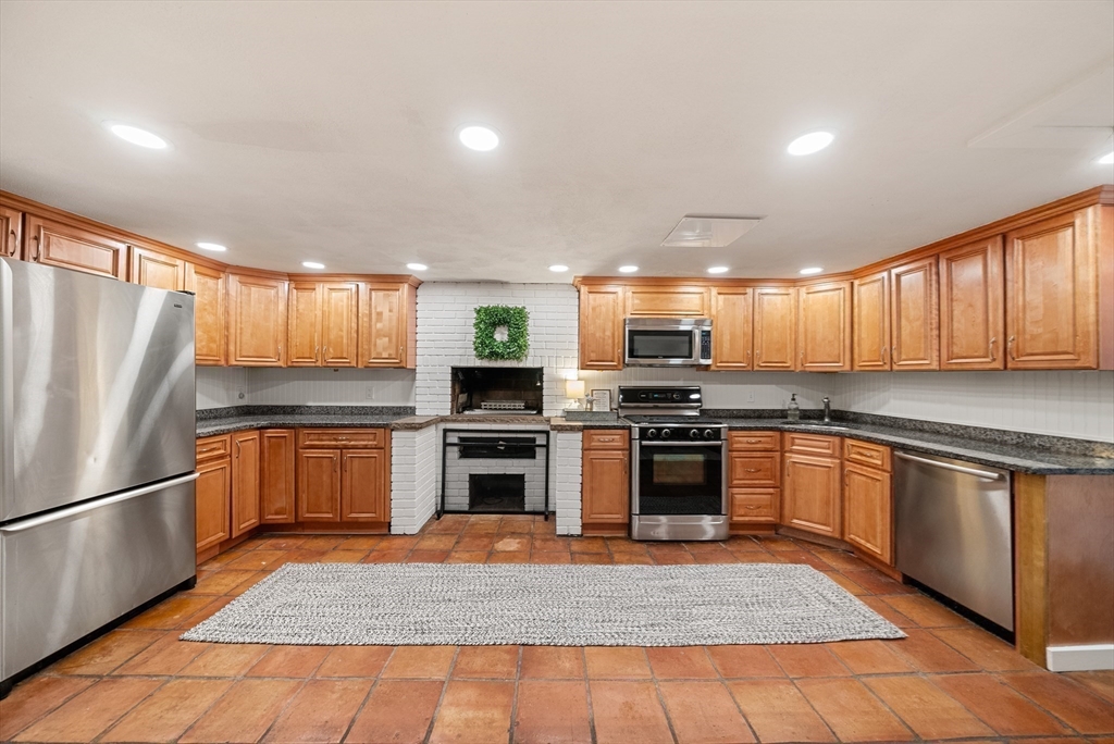 60 Perry Drive Westwood, MA 02090 - Photo 32 of 42 a kitchen with stainless steel appliances granite countertop a refrigerator stove top oven and sink
