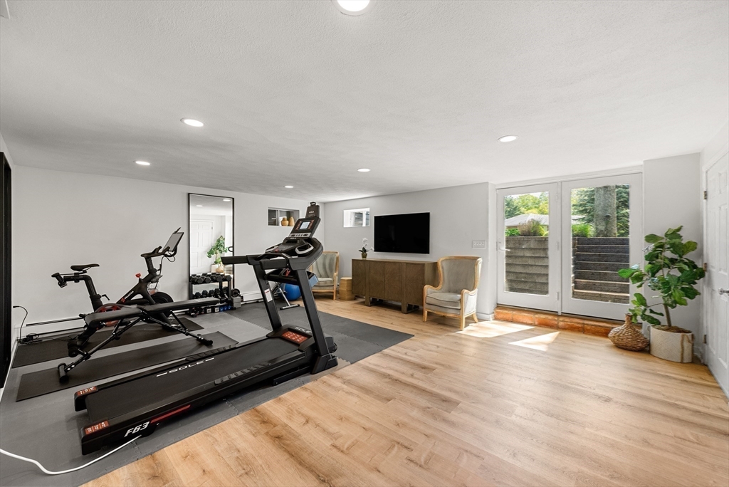 60 Perry Drive Westwood, MA 02090 - Photo 36 of 42 a living room with furniture flat screen tv and a large window