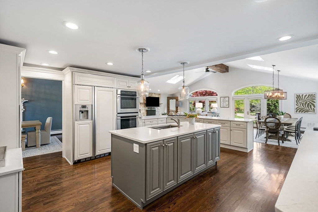 60 Perry Drive Westwood, MA 02090 - Photo 8 of 42 a kitchen with a sink counter top space stainless steel appliances and wooden floor