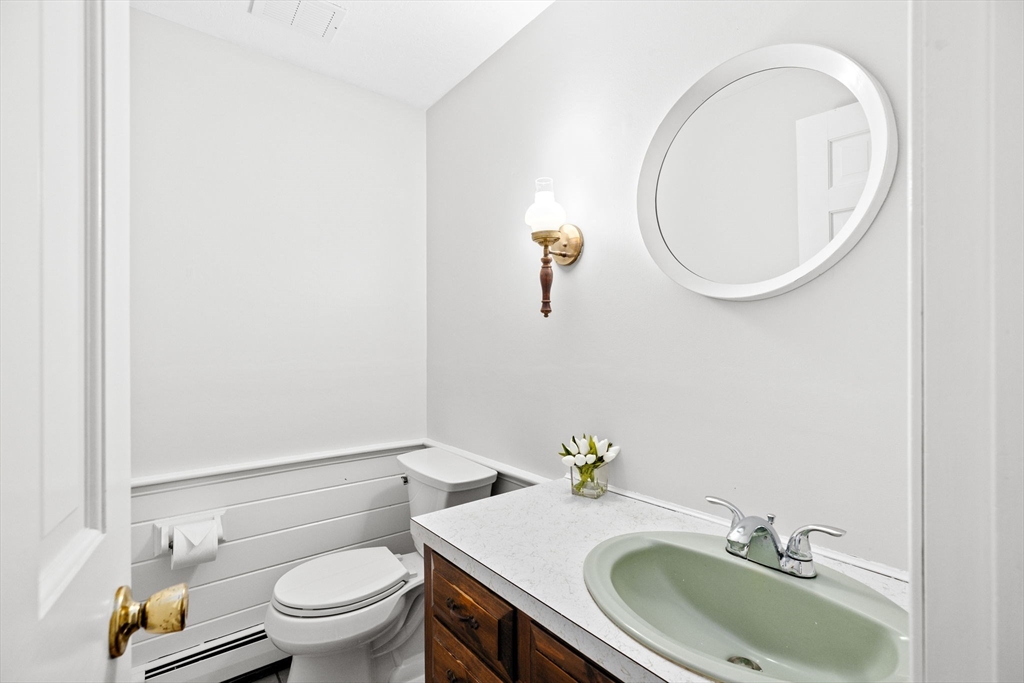 16 Liberty Road Hingham, MA 02043 - Photo 14 of 27 a white toilet sitting next to a bathroom sink