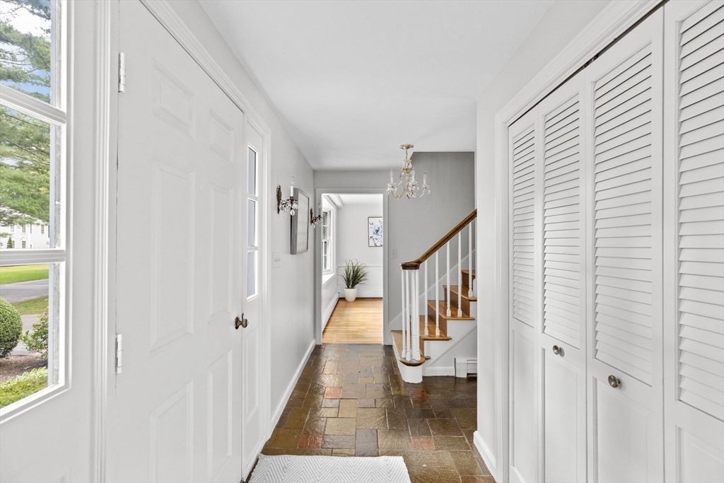 16 Liberty Road Hingham, MA 02043 - Photo 15 of 27 a view of staircase with lots of frames on wall and a potted plant