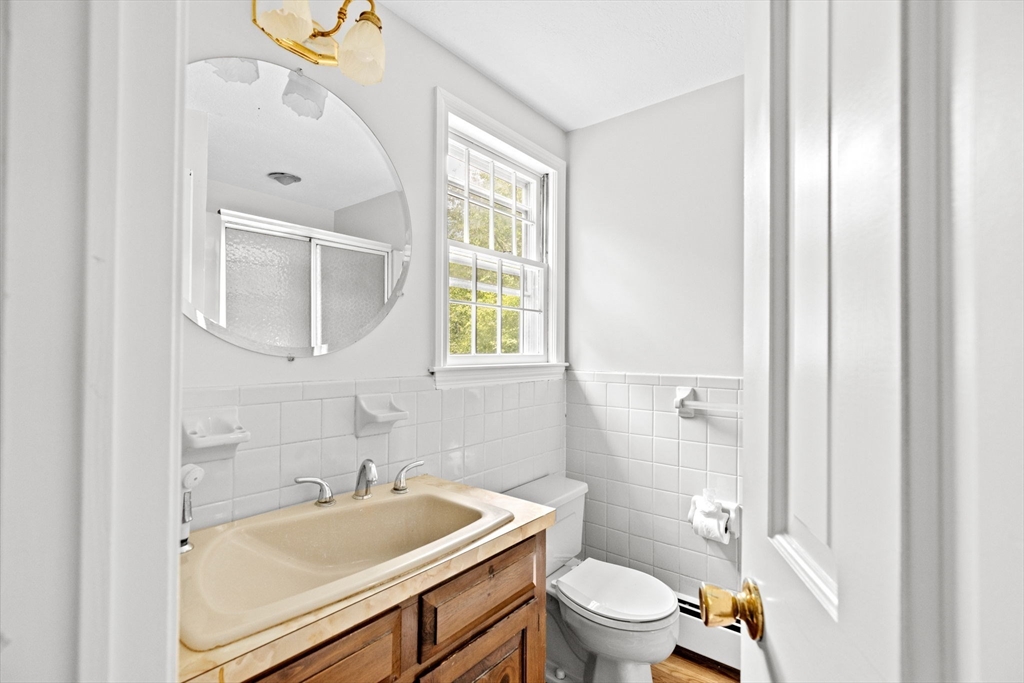 16 Liberty Road Hingham, MA 02043 - Photo 19 of 27 a bathroom with a sink toilet vanity and tub