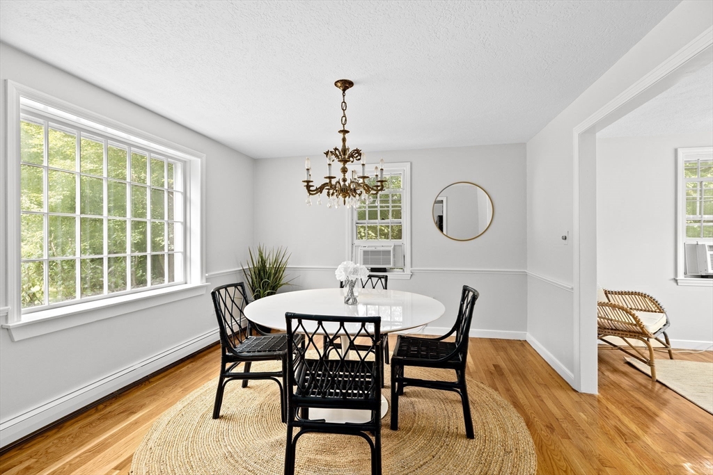 16 Liberty Road Hingham, MA 02043 - Photo 4 of 27 a dining room with chandelier and wooden floor