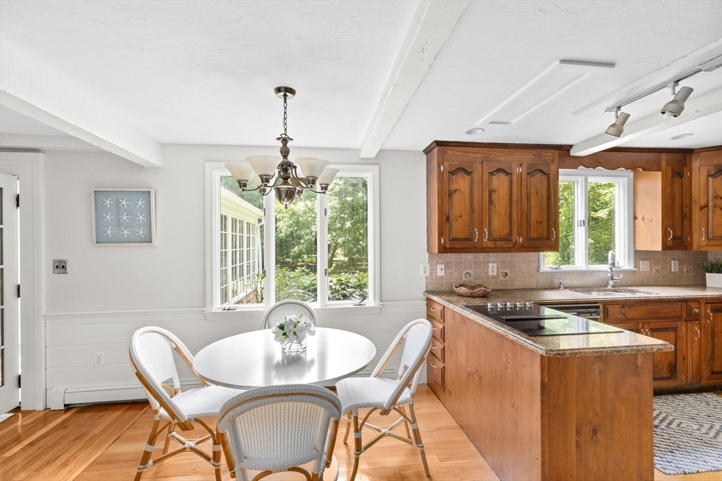16 Liberty Road Hingham, MA 02043 - Photo 7 of 27 a dining room with furniture a chandelier and wooden floor