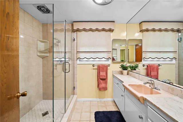 a bathroom with a double vanity sink mirror and shower