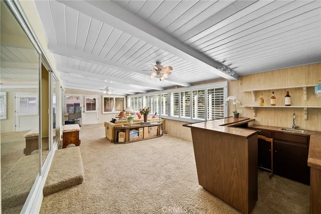 a bedroom with furniture and a large window