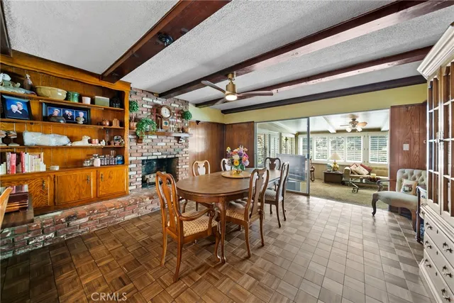 a dining room with furniture and a floor to ceiling window