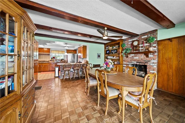 a view of a dining room with furniture and a chandelier