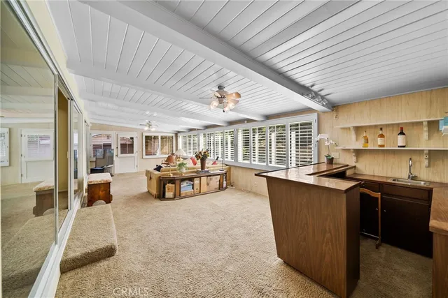 a bedroom with furniture and a large window