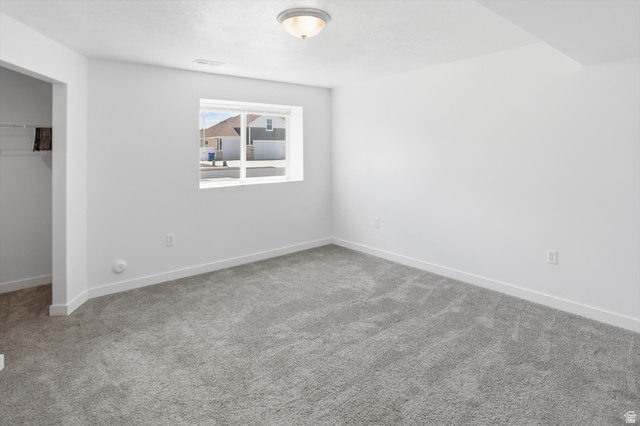 3636 West 910 South Syracuse, UT 84075 - Photo 18 of 70 Spacious room featuring light gray carpeting, crisp white walls, a single window, and a built-in closet with wire shelving