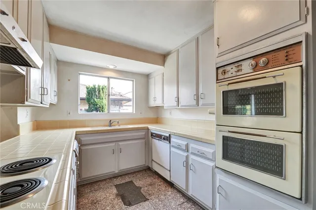a kitchen with a stove oven and sink