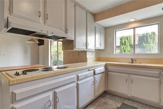 a kitchen with a sink stove and microwave