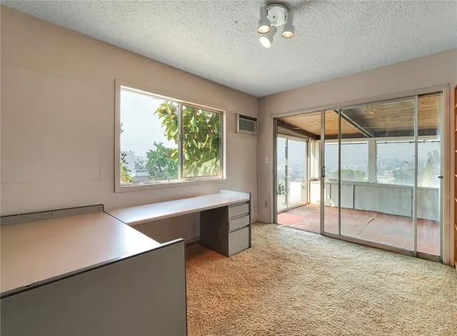 en empty room with sliding door and large window