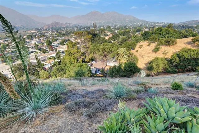 an aerial view of residential house with outdoor space and trees