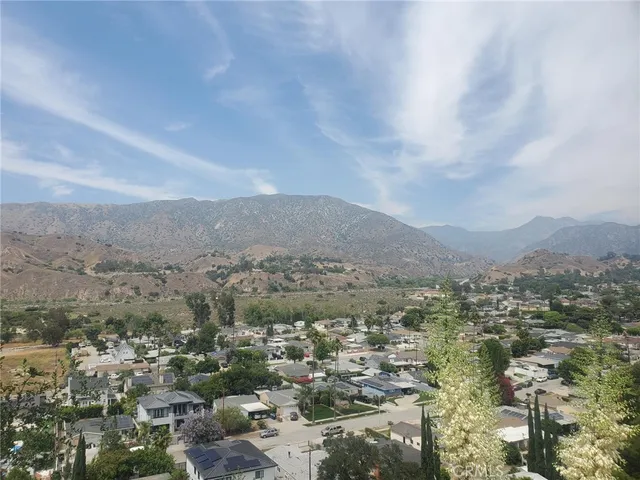 an aerial view of residential house with outdoor space and trees