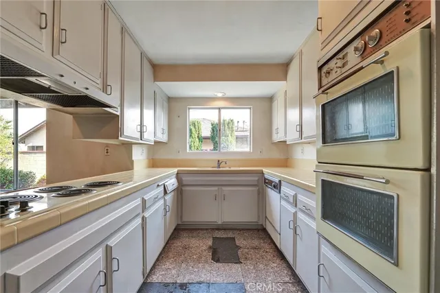 a kitchen with a sink stove and microwave