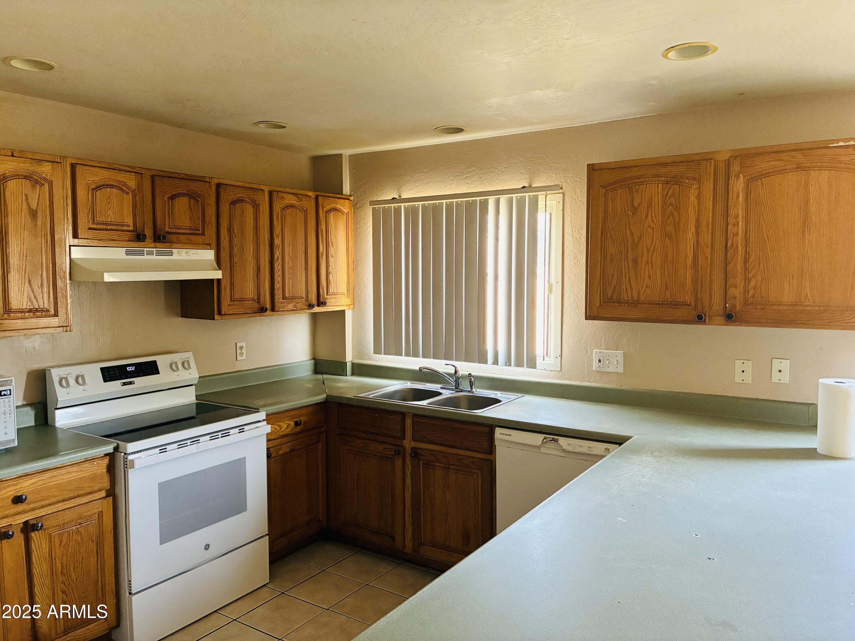 Undisclosed Address Tempe, AZ 85282 - Photo 3 of 23 a kitchen with a sink stove top oven and cabinets