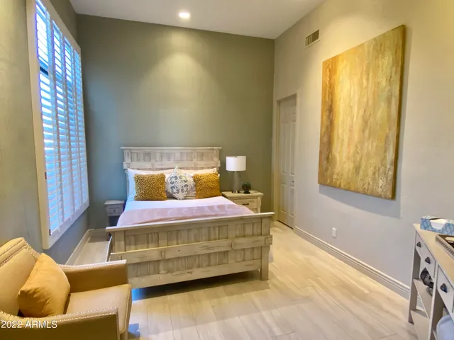 a bedroom with a bed and window