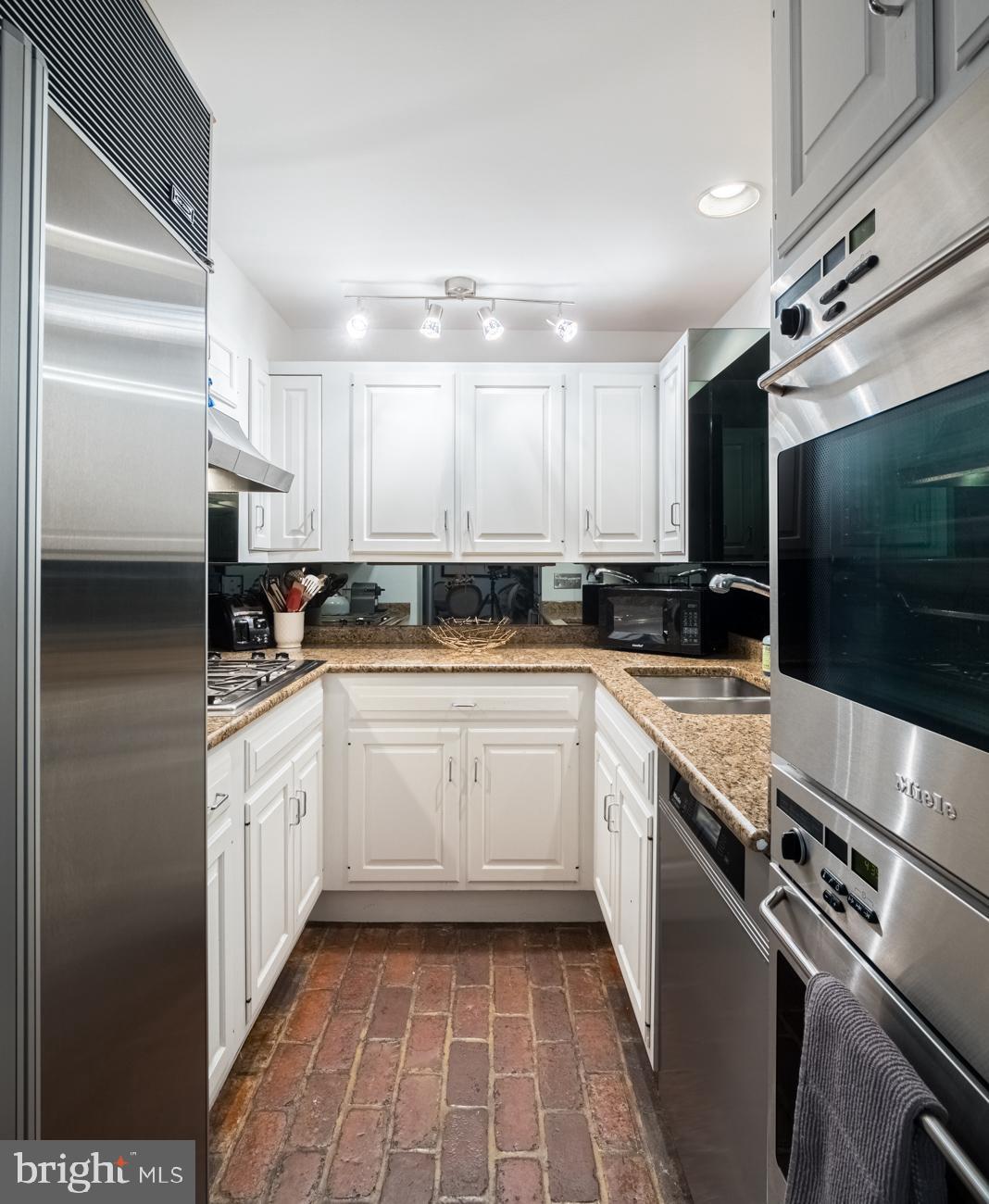 3500 P Street Northwest Washington, DC 20007 - Photo 9 of 15 a kitchen with stainless steel appliances granite countertop a stove a sink and a refrigerator