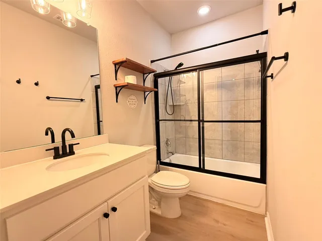 a bathroom with a sink toilet and shower