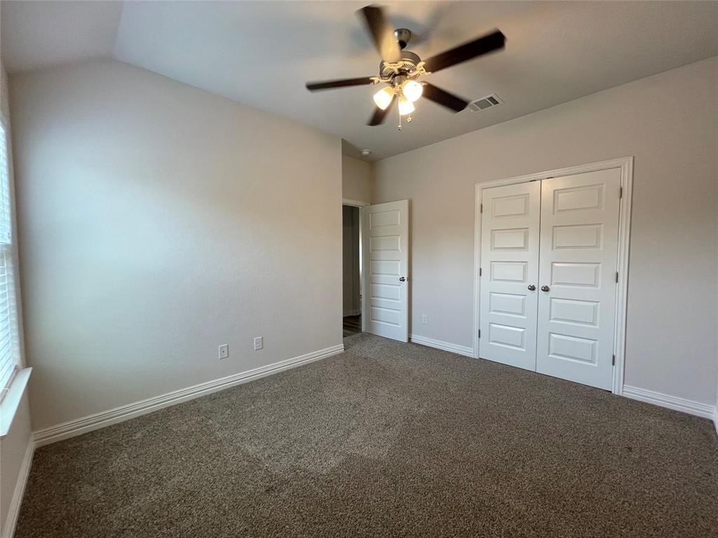 206 South Nolan River Road, Unit 6 Cleburne, TX 76033 - Photo 14 of 16 an empty room with windows and fan