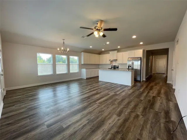 a view of a kitchen with a sink and a refrigerator