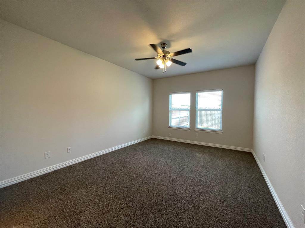206 South Nolan River Road, Unit 6 Cleburne, TX 76033 - Photo 4 of 16 an empty room with a window and a ceiling fan
