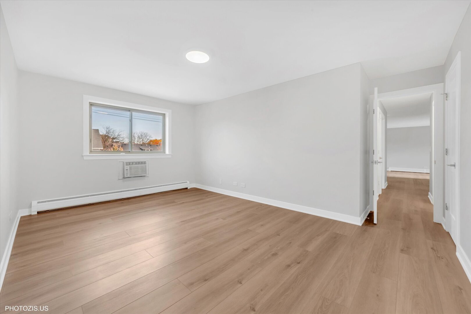 1640 West Sherwin Avenue, Unit 3B Chicago, IL 60626 - Photo 18 of 28 an empty room with wooden floor and windows
