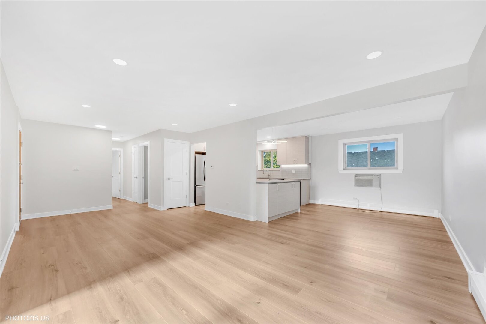 1640 West Sherwin Avenue, Unit 3B Chicago, IL 60626 - Photo 4 of 28 a view of an empty room with a window and wooden floor